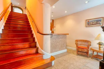 a staircase in a home with a chair and a table at O Cantinho da Mariazinha by Amazing Madeira in Funchal