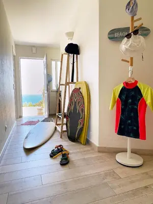 a room with surfboards and surfboards on the floor at 414 Casa Colina Mar in Salema
