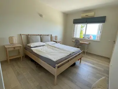 a bedroom with a bed and a window at 414 Casa Colina Mar in Salema
