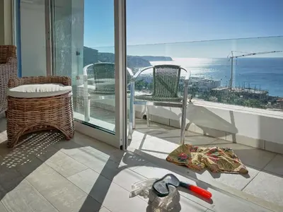 a room with a balcony with a view of the ocean at 414 Casa Colina Mar in Salema
