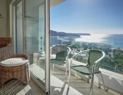 a balcony with chairs and a view of the ocean at 414 Casa Colina Mar in Salema