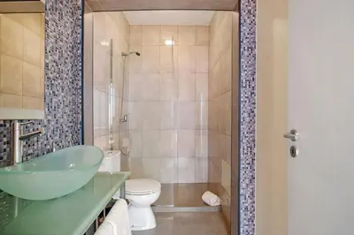 a bathroom with a sink and a toilet and a shower at Sunparadise in Arco da Calheta