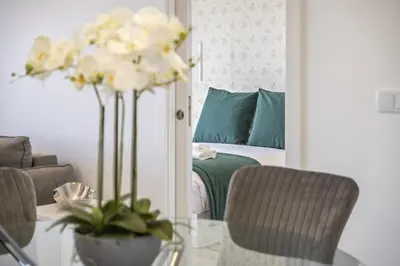 a living room with a table and a bed at Contemporary Residence B by Homie in Funchal