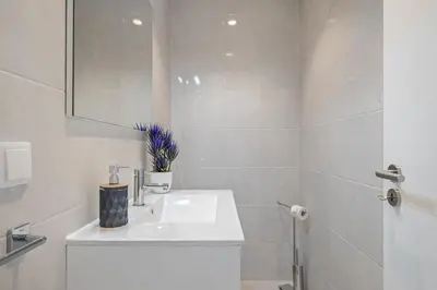 a white bathroom with a sink and a mirror at Contemporary Residence B by Homie in Funchal