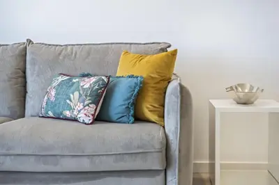 a gray couch with colorful pillows on it at Contemporary Residence C by Homie in Funchal