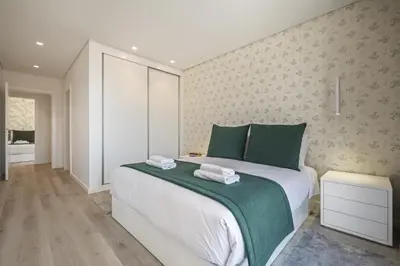 a bedroom with a large bed with green pillows at Contemporary Residence C by Homie in Funchal