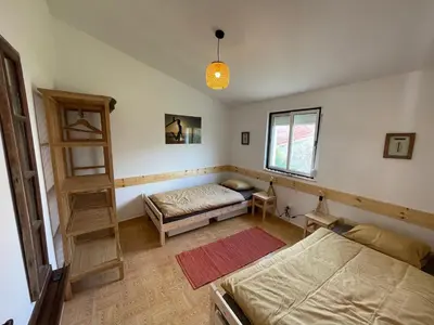 a bedroom with two beds and a book shelf at Algarve Surf Hostel & Guest House in Raposeira