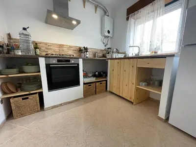 a kitchen with a sink and a stove top oven at Algarve Surf Hostel & Guest House in Raposeira