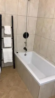a bath tub in a bathroom with towels at Casa do Amigo in Seixal