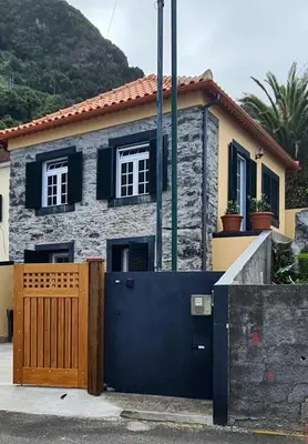 a house with a wooden gate in front of it at Casa do Amigo in Seixal