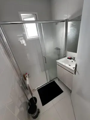 a white bathroom with a shower and a sink at Home Away From Home in Funchal