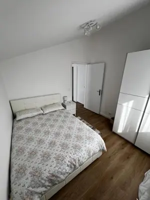 a white bedroom with a large bed and two closets at Home Away From Home in Funchal