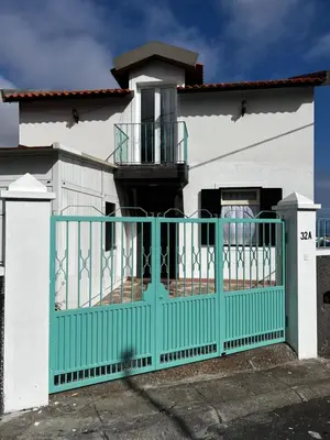 a house with a green gate in front of it at Home Away From Home in Funchal