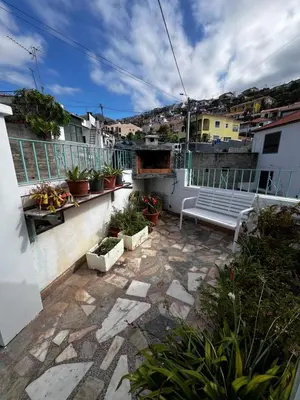 a patio with a bench on a balcony at Home Away From Home in Funchal