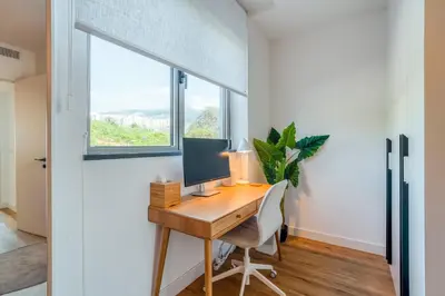 a home office with a desk and a window at The Pink Palm Apartment by Amazing Madeira in Funchal