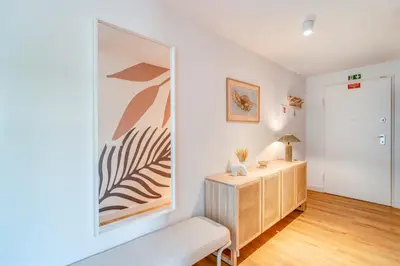 a living room with a desk and a couch at The Pink Palm Apartment by Amazing Madeira in Funchal