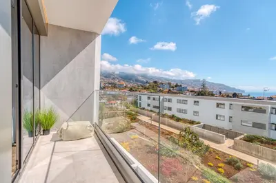a balcony with a view of a building at The Pink Palm Apartment by Amazing Madeira in Funchal