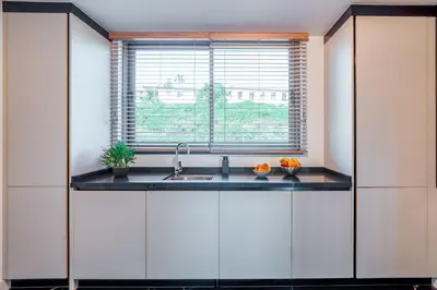 a kitchen with a sink and a window at The Pink Palm Apartment by Amazing Madeira in Funchal