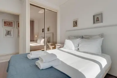 a bedroom with a large white bed with two towels on it at Old Town Apartment in Funchal