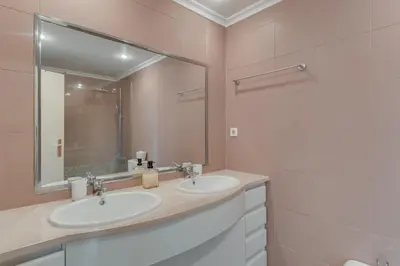 a bathroom with two sinks and a large mirror at Old Town Apartment in Funchal