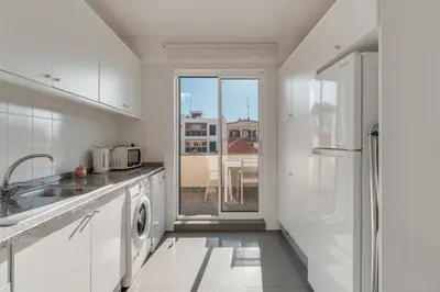 a white kitchen with a sink and a dishwasher at Old Town Apartment in Funchal