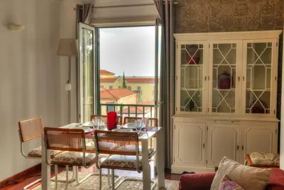 a dining room with a table and chairs and a window at Old Town Apartment in Funchal
