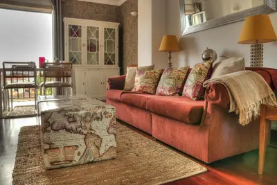 a living room with a red couch and a table at Old Town Apartment in Funchal