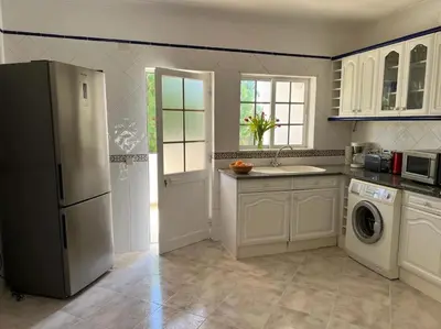 a kitchen with a refrigerator and a washer and dryer at Apartamento Caravela em Burgau - NEW LISTING in Burgau