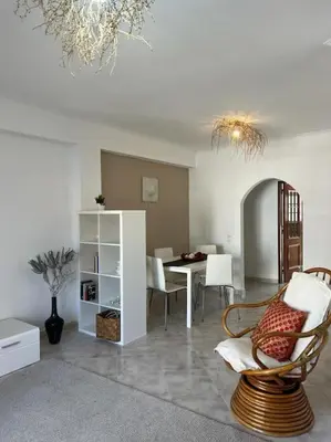 a living room with a table and chairs and a chandelier at Apartamento Caravela em Burgau - NEW LISTING in Burgau