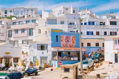 a group of white buildings in front of a city at Apartamento Caravela em Burgau - NEW LISTING in Burgau