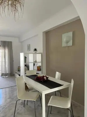 a dining room with a white table and chairs at Apartamento Caravela em Burgau - NEW LISTING in Burgau