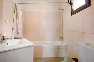 a bathroom with a sink and a bath tub at Casa da Bemposta in Machico