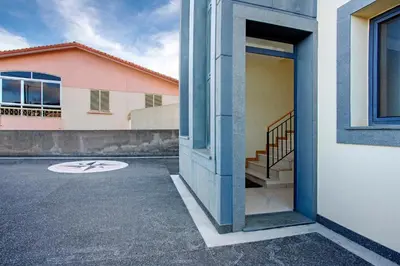 an open door of a building next to a street at Casa da Bemposta in Machico