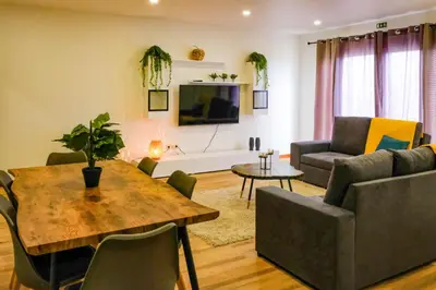 a living room with a table and a couch at Casa do Simão Gaula in Santa Cruz