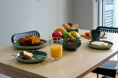 a room with two beds and a chair in it at Casa do Simão Gaula in Santa Cruz