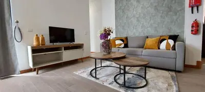 a living room with a couch and a table at Villa City in Funchal