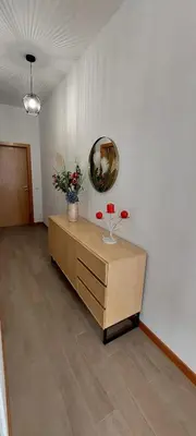 a room with a dresser with a mirror and flowers on it at Villa City in Funchal