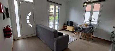 a living room with a couch and a table with chairs at Villa City in Funchal