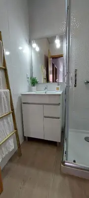 a bathroom with a sink and a shower with a mirror at Villa City in Funchal