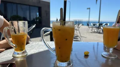 two glasses of orange juice sitting on a table at Apartment in Camara de Lobos not shared in Câmara de Lobos