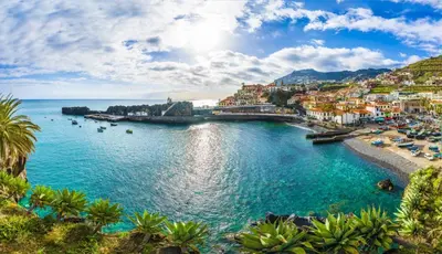 a view of a beach with a town and the ocean at Apartment in Camara de Lobos not shared in Câmara de Lobos