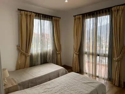 a bedroom with two beds and a large window at House Lourdes & Manuel in Machico