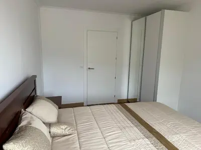 a bedroom with a large bed and a closet at House Lourdes & Manuel in Machico