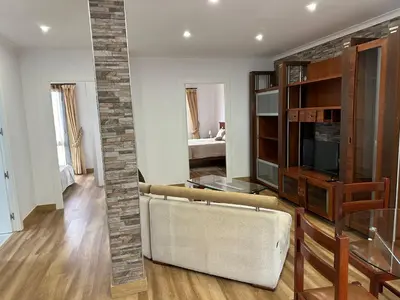 a living room with a couch and a glass table at House Lourdes & Manuel in Machico