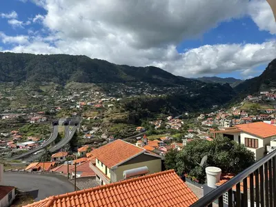 a view of a city with a road and a mountain at House Lourdes & Manuel in Machico