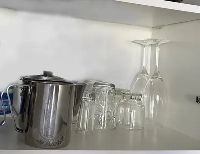 a group of glass jars and bottles on a shelf at Apartamento do Mar e Lua in Funchal