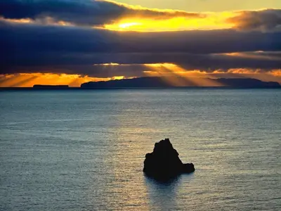 a rock in the middle of a large body of water at Apartamento do Mar e Lua in Funchal