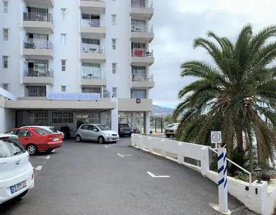 a parking lot in front of a building at Apartamento do Mar e Lua in Funchal