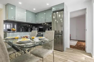 a kitchen with a glass table and chairs with food on it at City Haven by Homie in Funchal