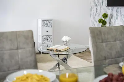a glass table with books on it with two chairs at City Haven by Homie in Funchal